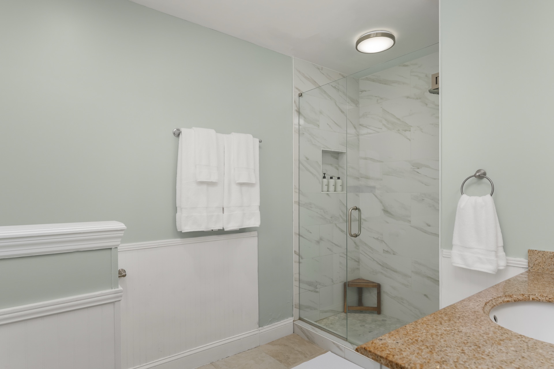 En-suite bathroom at Shell Yeah with a marble-tiled walk-in shower