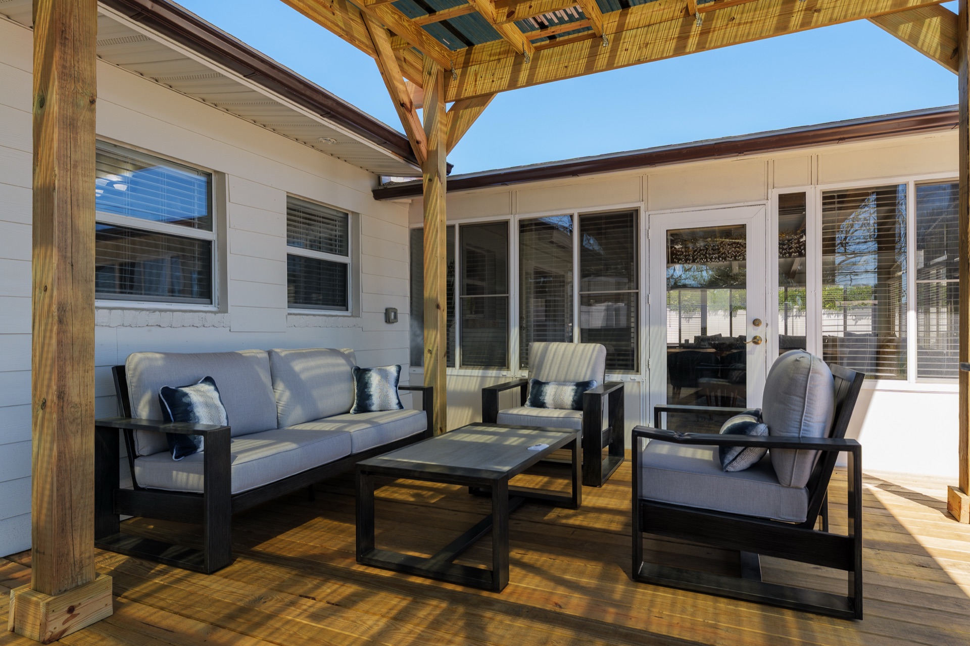 Covered outdoor lounge at Shell Yeah with comfortable seating for evenings outside