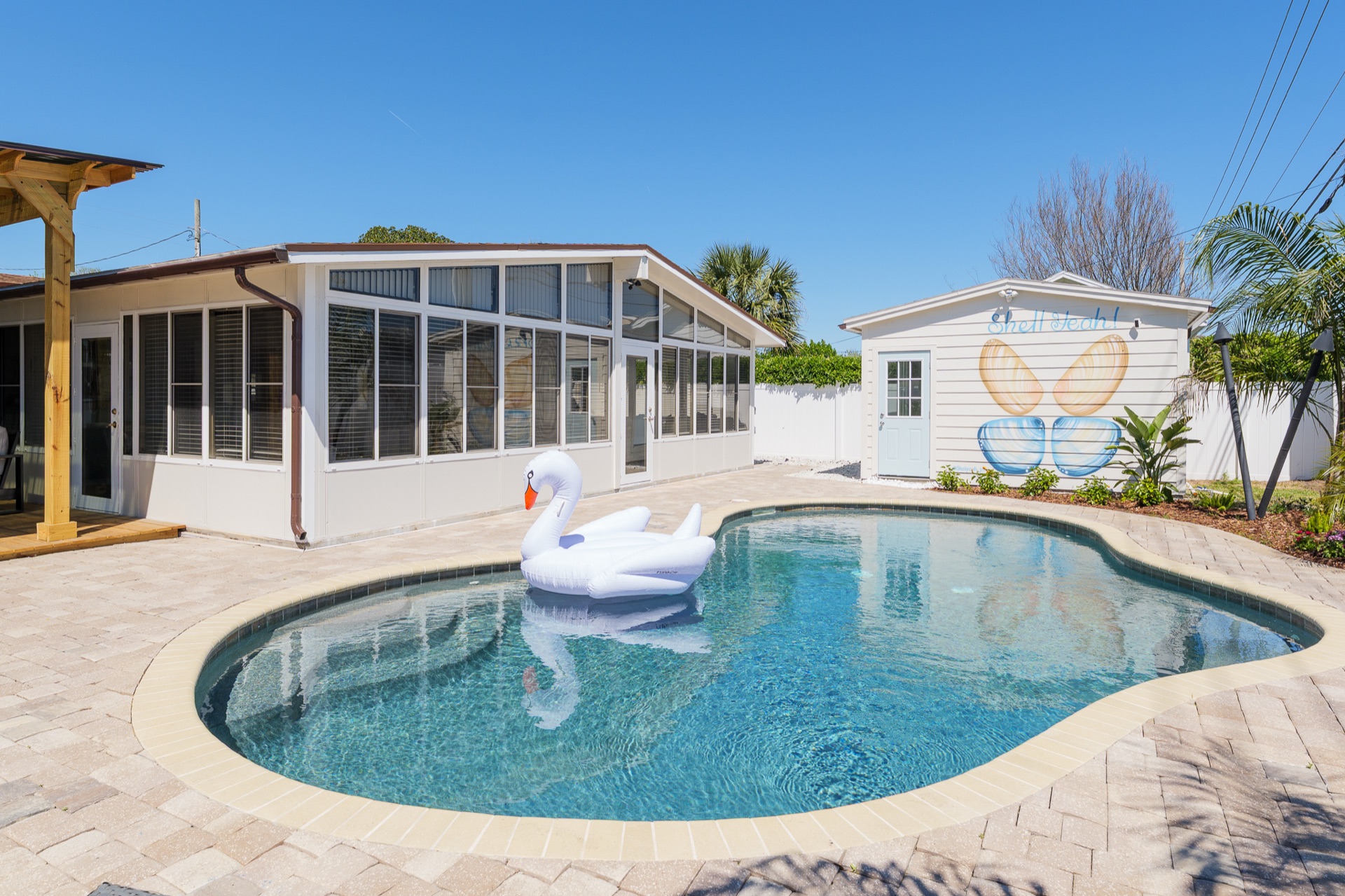 The heated saltwater pool in the backyard at Shell Yeah with loungers on the deck