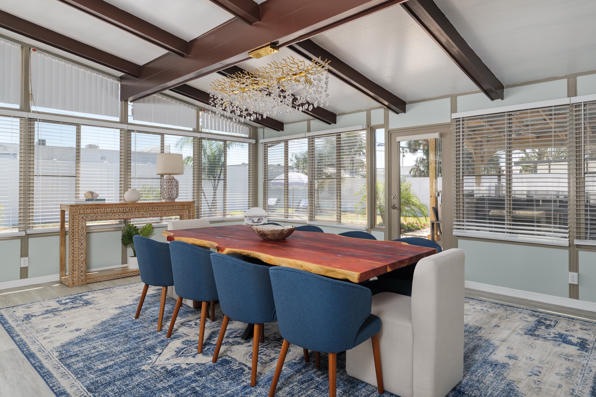 Sunroom dining space at Shell Yeah with a live-edge table that seats up to 10