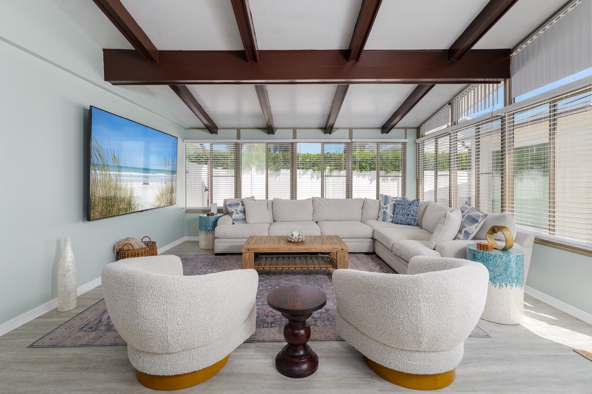 Second living area in the sunroom at Shell Yeah with a large sectional and TV